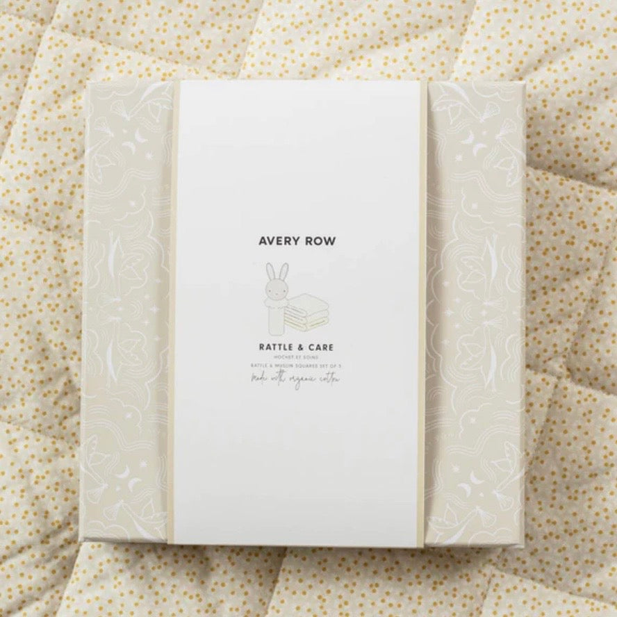 Packaged gift set with 'Avery Row' branding on a textured fabric background
Gift set includes set out three muslin squares and a rattle
