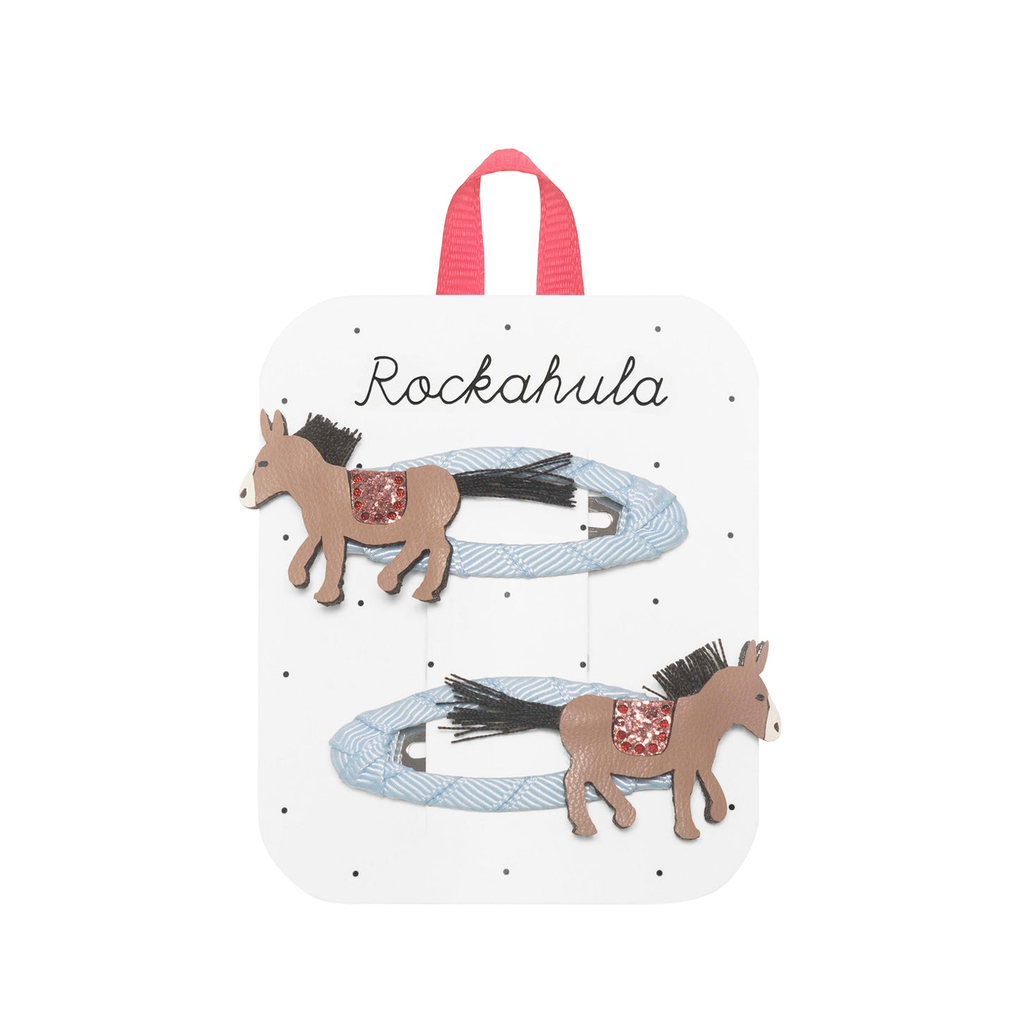 Packaged hair accessories with horse designs on a white background, featuring the brand 'Rockahula'.
