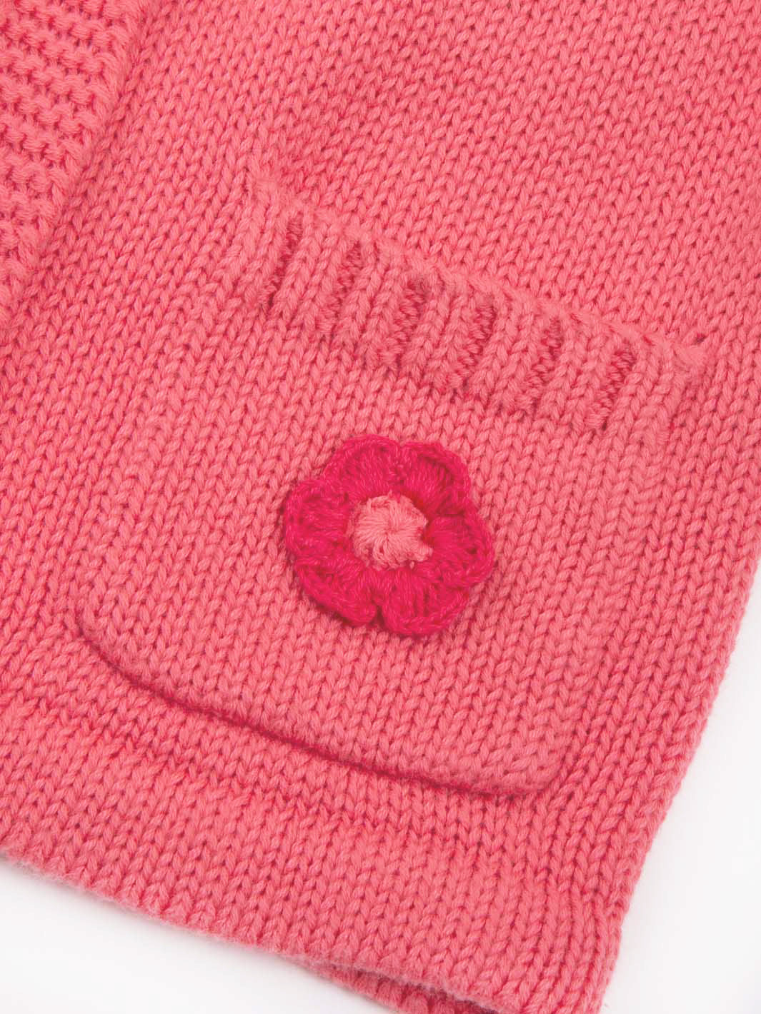 Close up on pocket. Embroidered flower on organic cotton pink cardigan
A lovely gift for babies