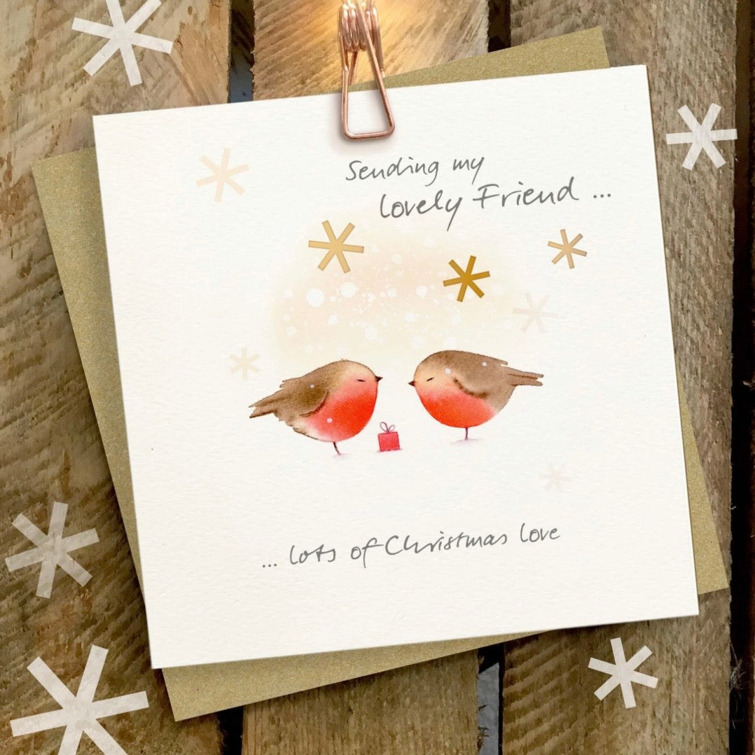 A square greeting card with a watercolor illustration of two robins facing each other, with the text 'Sending my lovely Friend .
Ginger Betty Cards
Christmas Cards
Christmas
Lovely friends
Friend
Robins
Printed in the UK