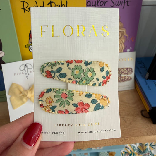White card displaying two Liberty Hair Clips by FLORAS. The hair clips have a cream base with a colourful floral pattern in green, red, and yellow.

Hair Clips
Liberty Print
Gift inspiration 
Floral