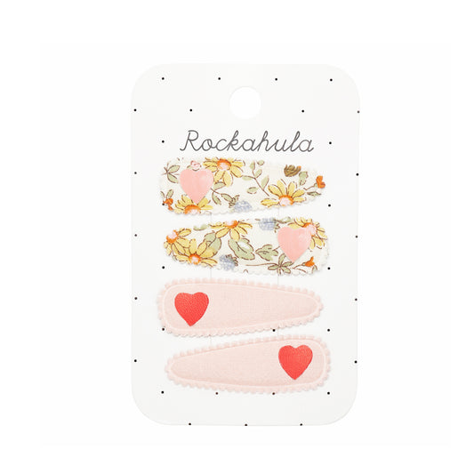 Set of four hair accessories with floral and heart designs on a Rockahula branded card.