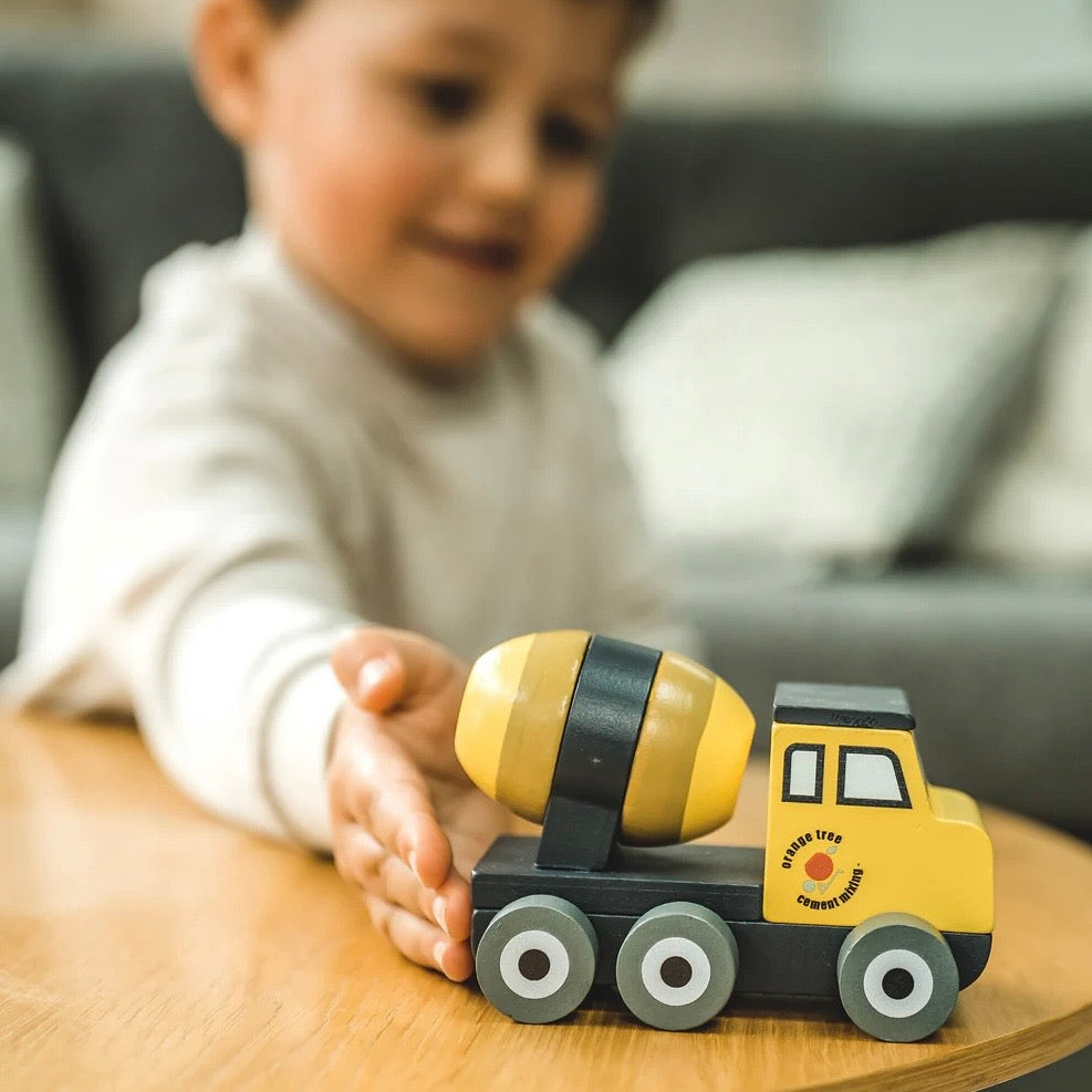 Child playing with our wooden Cement Mixer push toy
