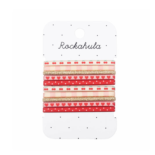 Set of ten hair ties with red and gold patterns on a Rockahula branded card.