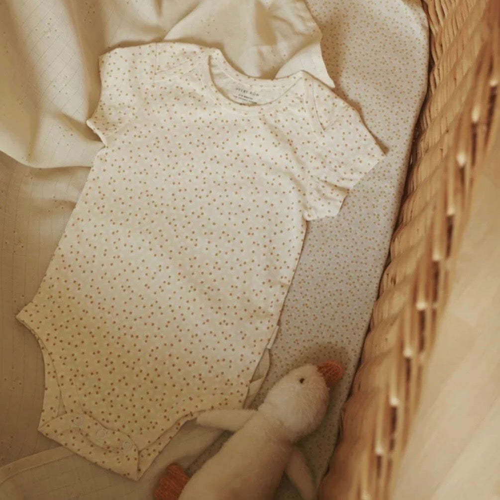 Baby onesie with subtle pattern in a wicker basket
A stylish bodysuit, perfect gift for new babies