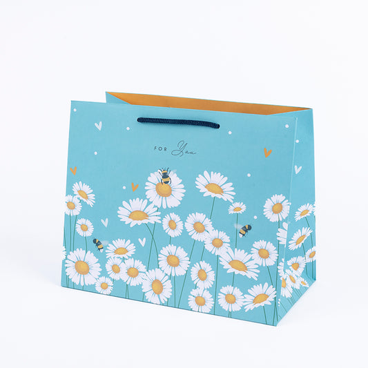 Large gift bag with daisies on a blue background
