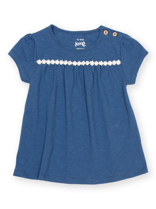 Blue tunic with white floral details on a white background
Children's clothing