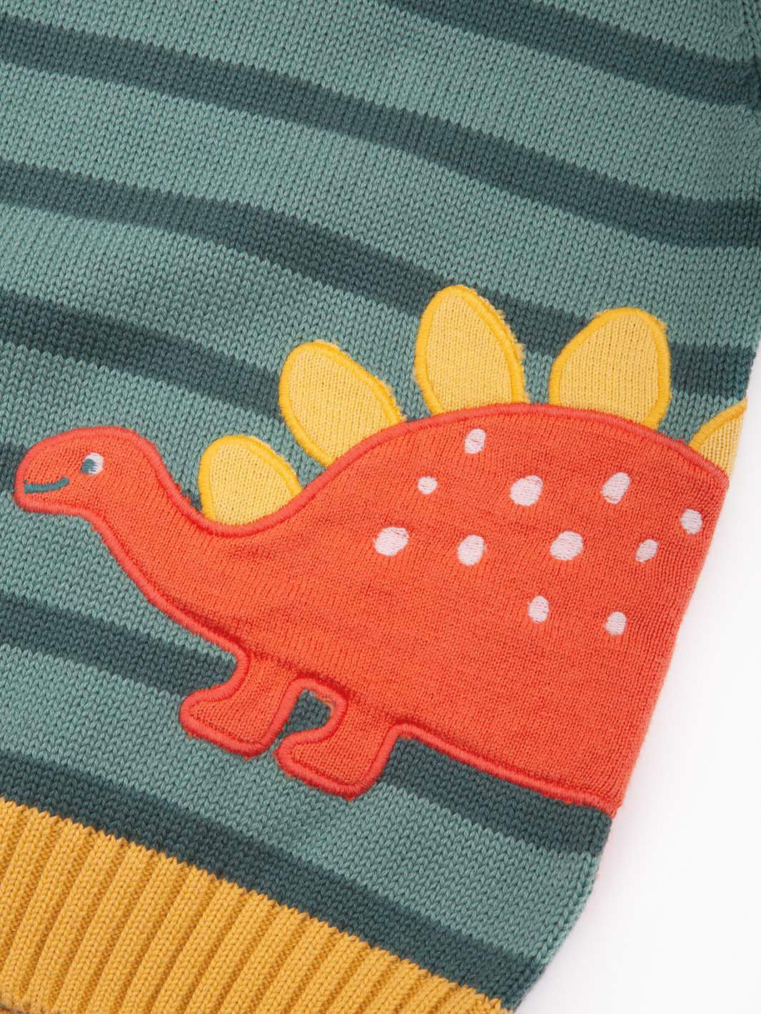 Close up of dinosaur appliqué on front of jumper
