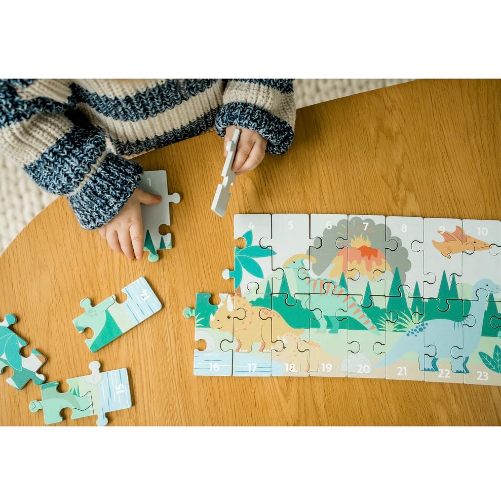 Child making our wooden Dinosaur Number Puzzle