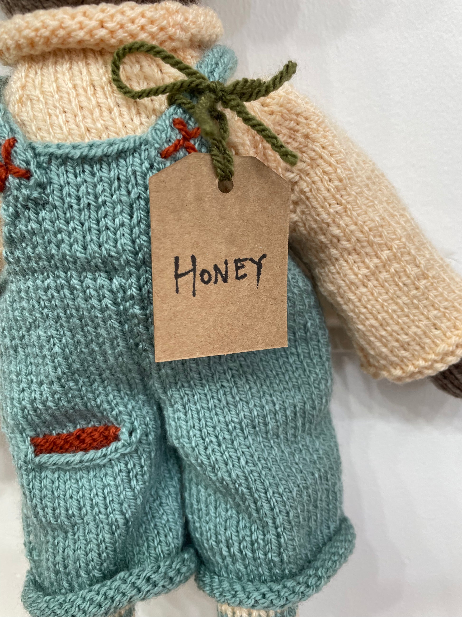 Tag showing the name of honey the bear