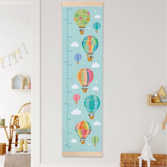 Growth chart with colorful hot air balloons on a light blue background in a room setting.