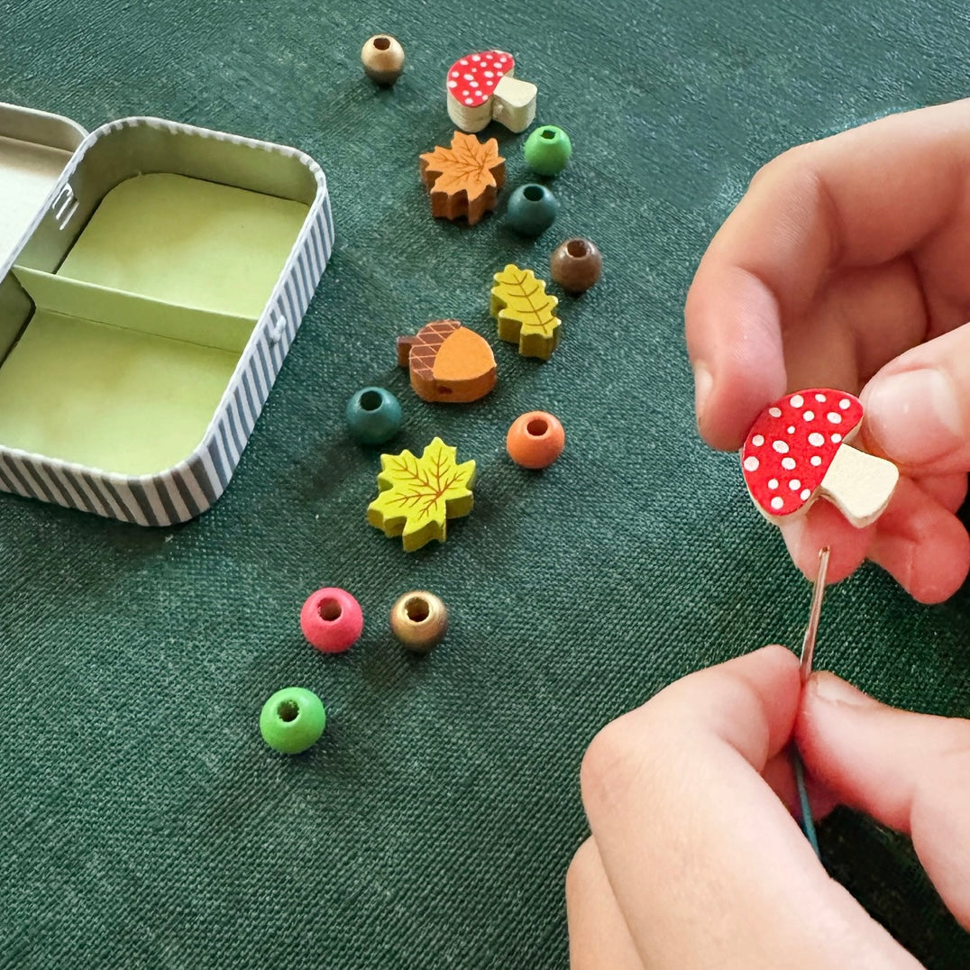 Child making our Forest Bracelet
