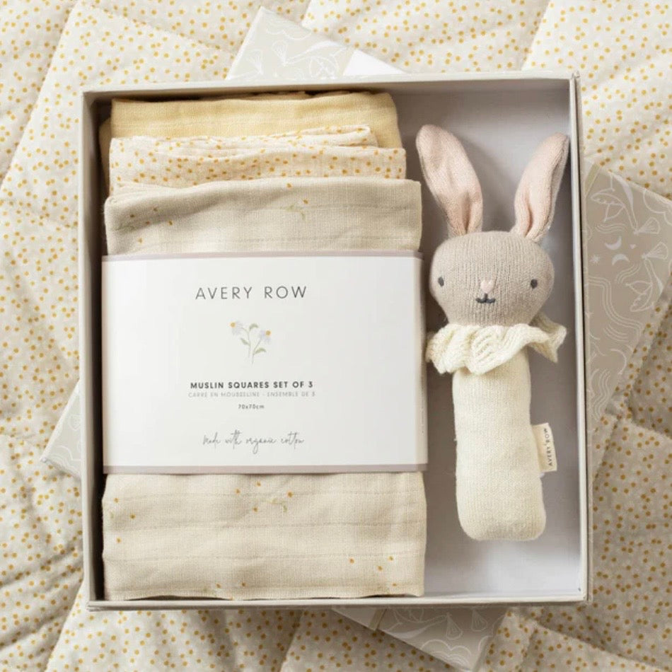 Baby gift set with muslin squares and a plush toy in a box on a patterned background
A lovely new baby gift