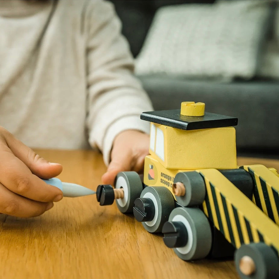 Child making our wooden Buildable Digger