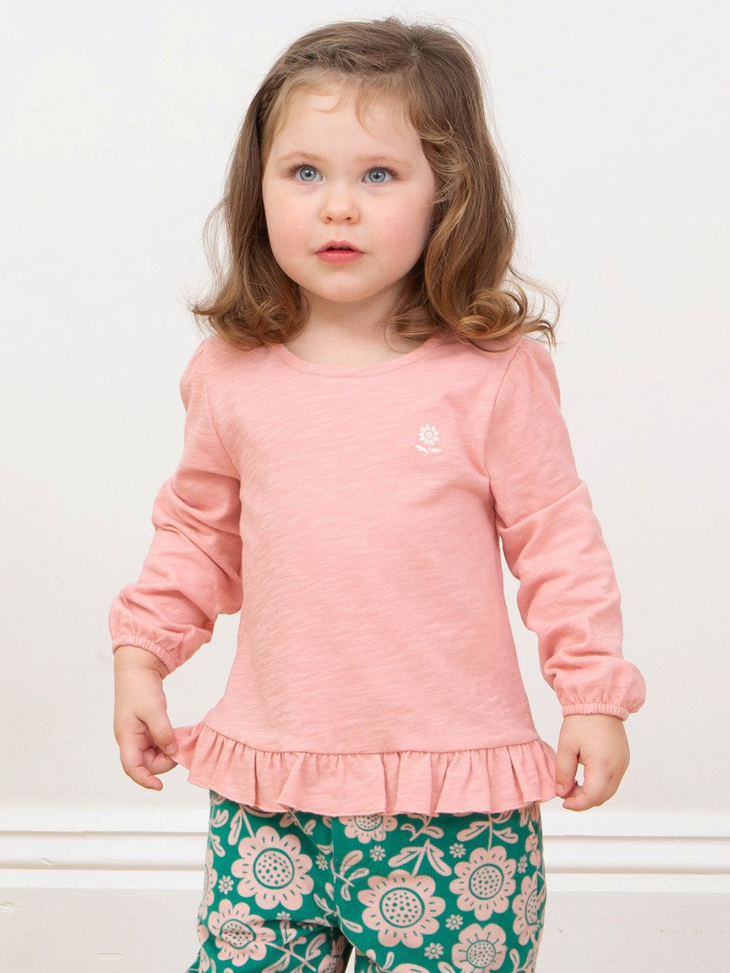 Girl wearing our pink tunic with folks cords 