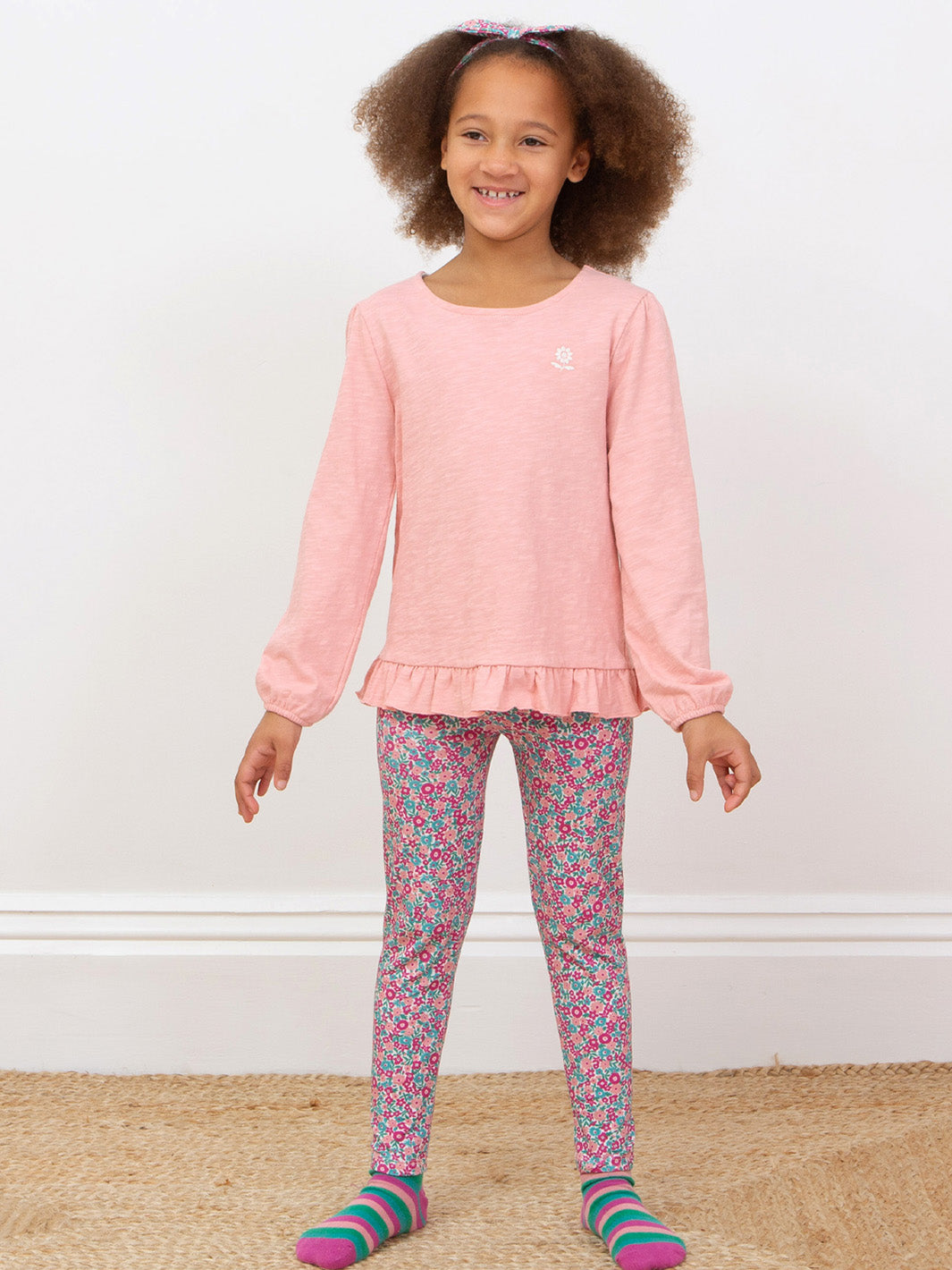 Girl wearing our pink tunic with matching ditsy tales leggings. 
All made from organic cotton 