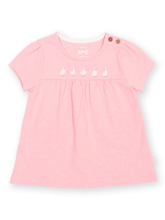 Childs pink tunic with embroidered details on a white background