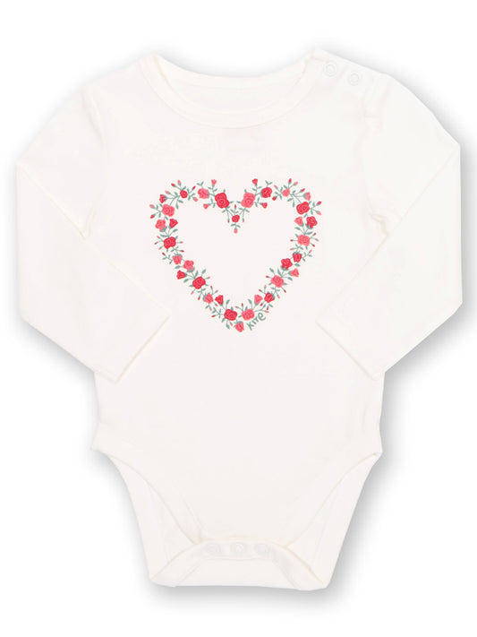 White baby onesie with a floral heart design on a white background