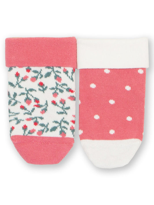 Two pairs of socks with floral and polka dot patterns on a white background