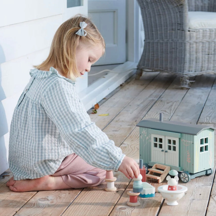 Child playing with our Shepherds Hut  on decking. 