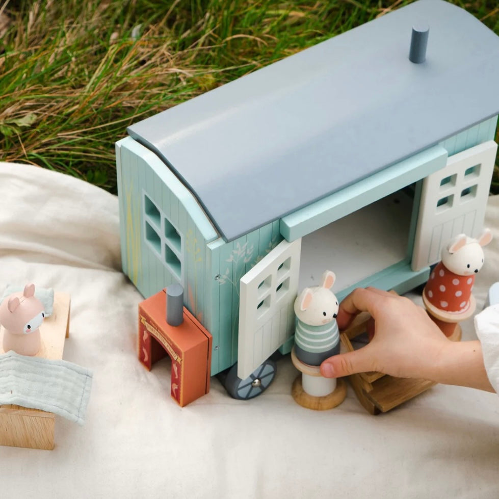Our wooden Shepherds Hut being played with outside, figures on the steps outside the open doors of the Shepherds Hut 