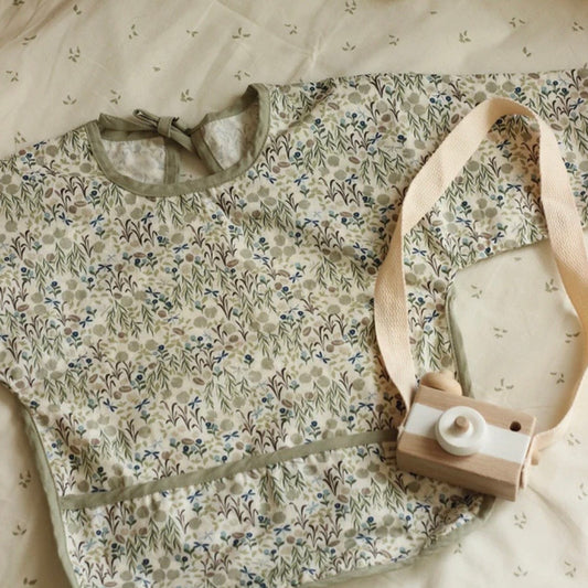 Green floral sleeved bib. Perfect of babies and children of meal times and messy play