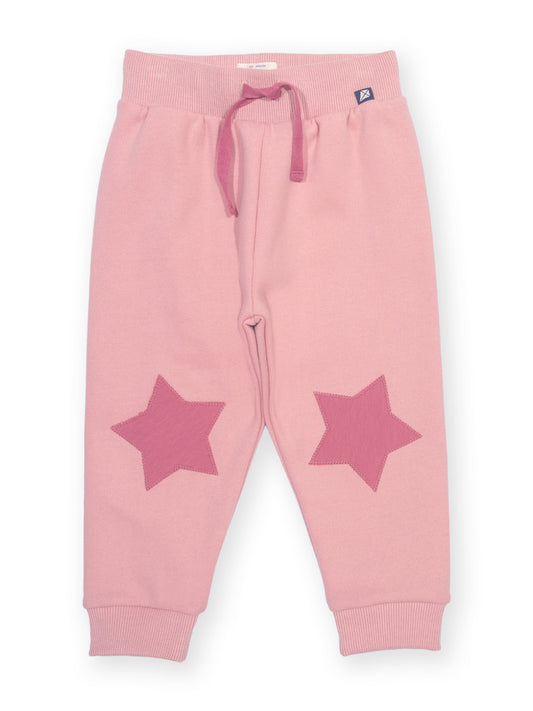 Pink jogger pants with a drawstring waist and two large pink star patches on the lower legs, shown flat on a white background.

Children's clothing
Organic cotton 
Kids clothing
Kite clothing
Joggers
Star
