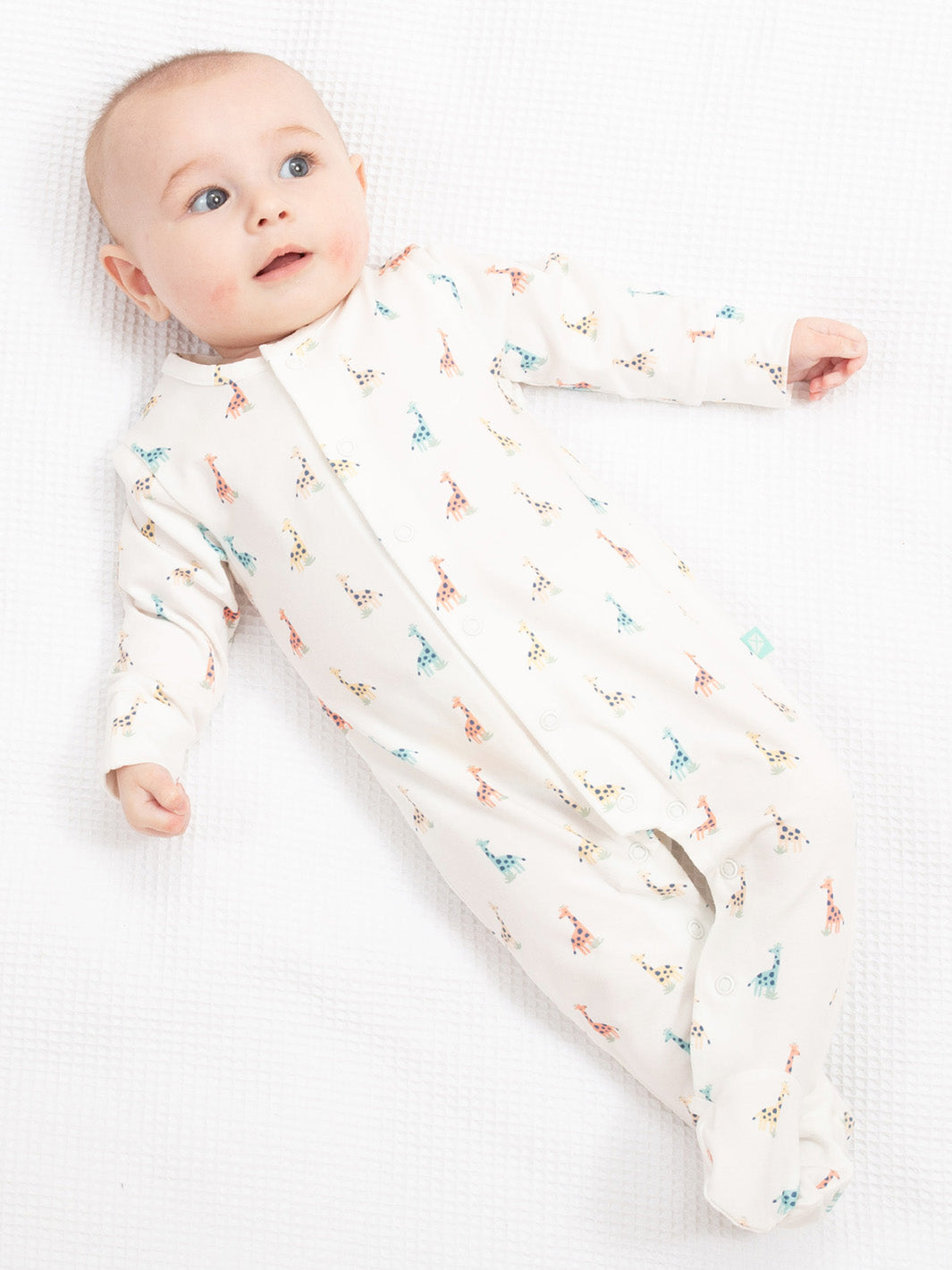 Baby in a white sleepsuuit with colourful giraffe print on a white background

Baby clothing 
Organic cotton 
Sleepsuit 
Giraffe print 
Kite clothing 
New baby gift
