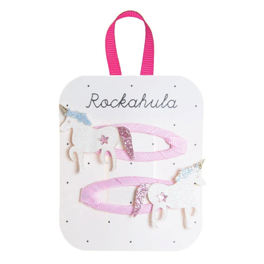 Product packaging with 'Rockahula' branding featuring pink ribbons and decorative elements on a white background.
Unicorn themed hair clips