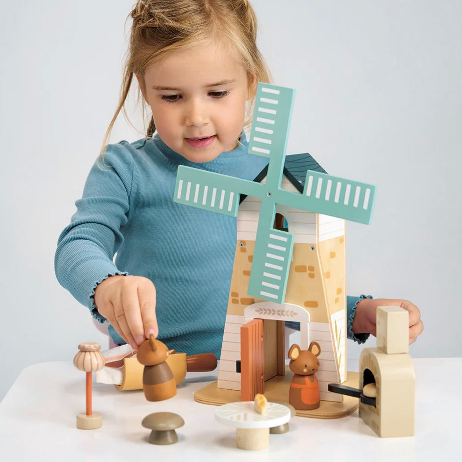 Child playing with our Wooden Windmill play set