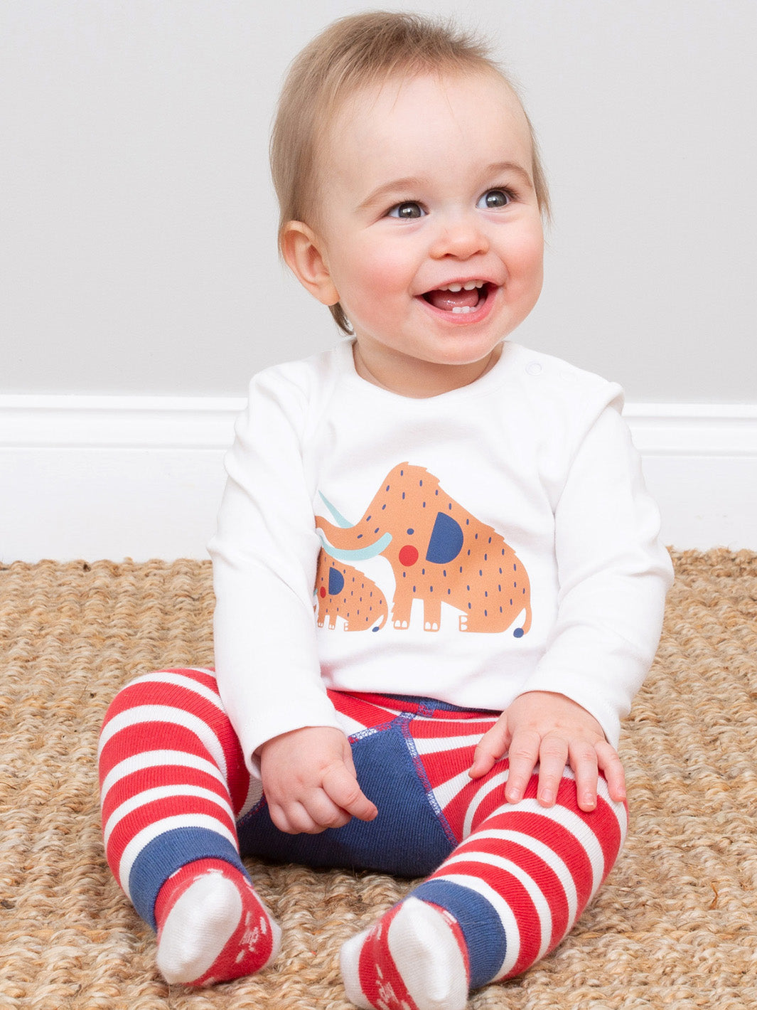Baby wearing our woolly mammoth bodysuit and knitted leggings