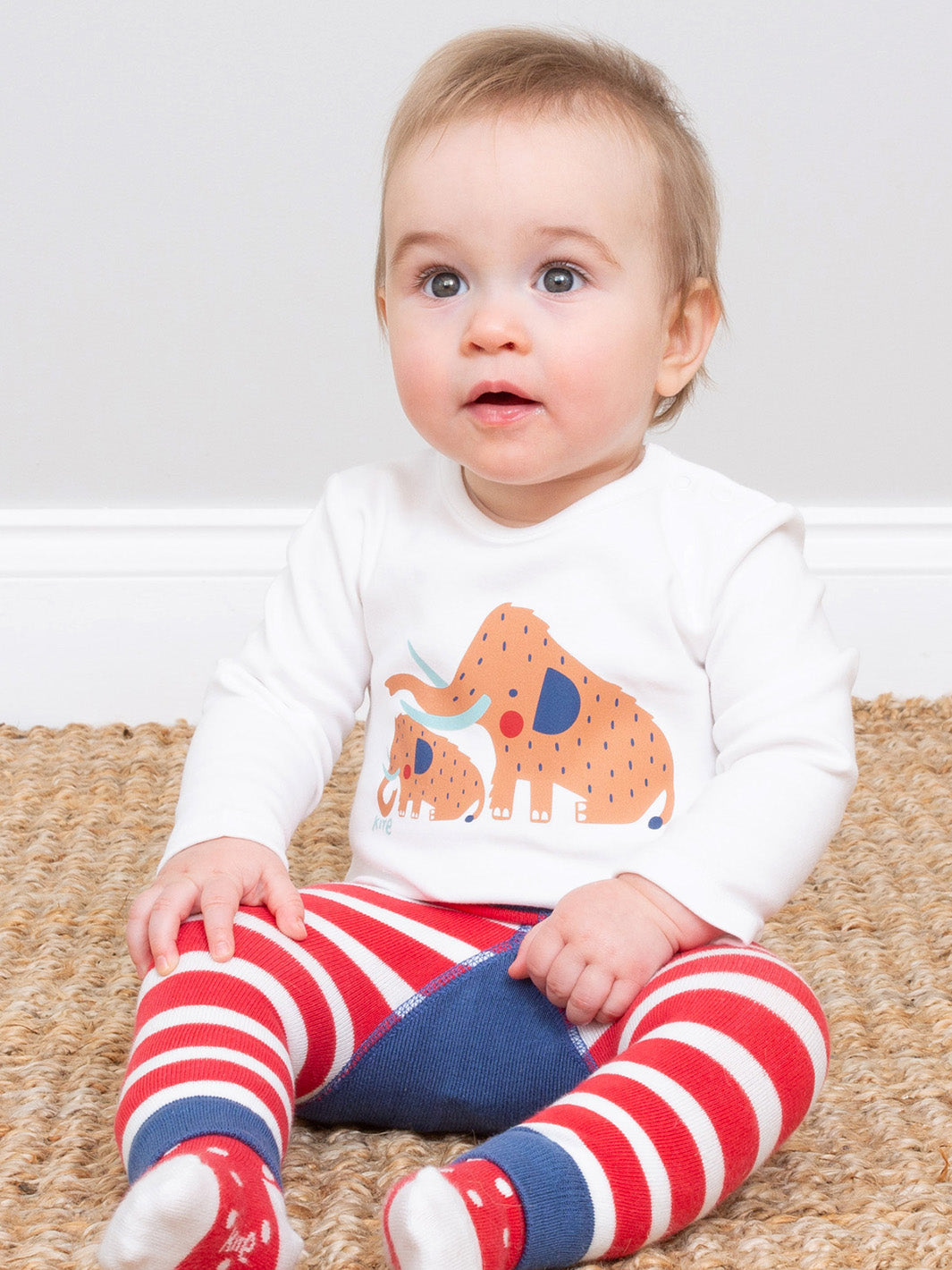 Baby wearing our woolly mammoth bodysuit and knitted leggings