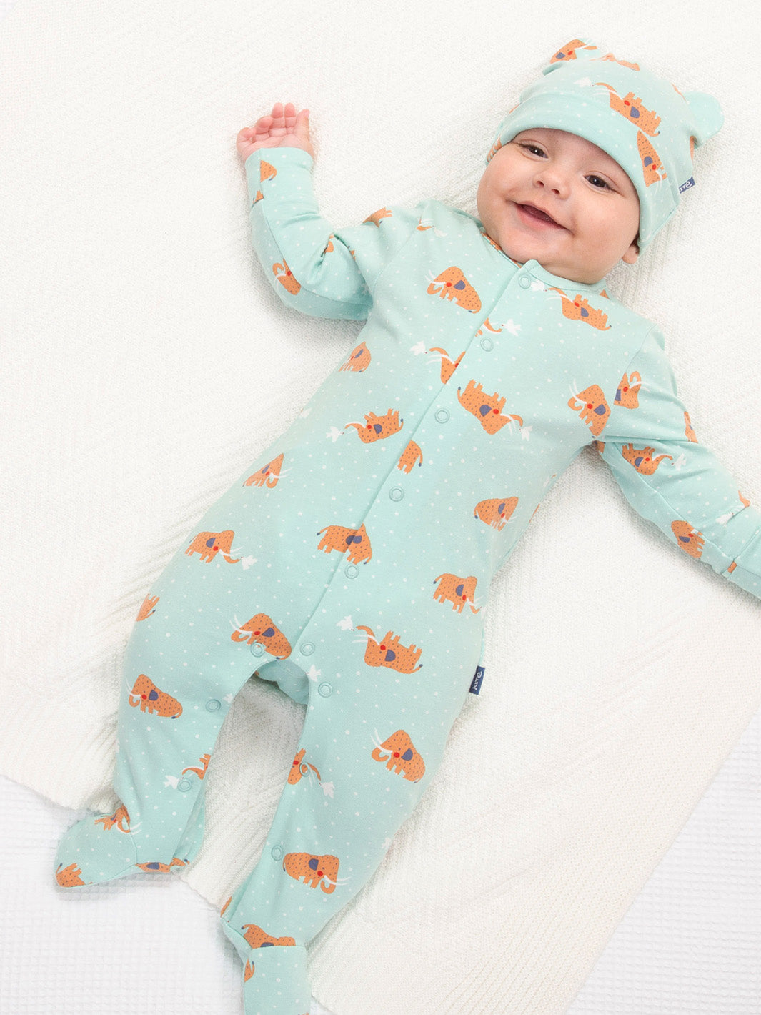 Baby wearing our woolly mammoth sleepsuit and hat